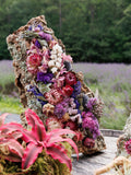 Decorative rock with colorful flowers in a natural setting